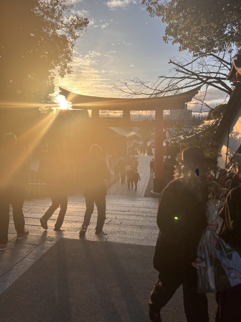 Kyoto Fushimi Inari at sunset — Golden light streaming through the torii gates.