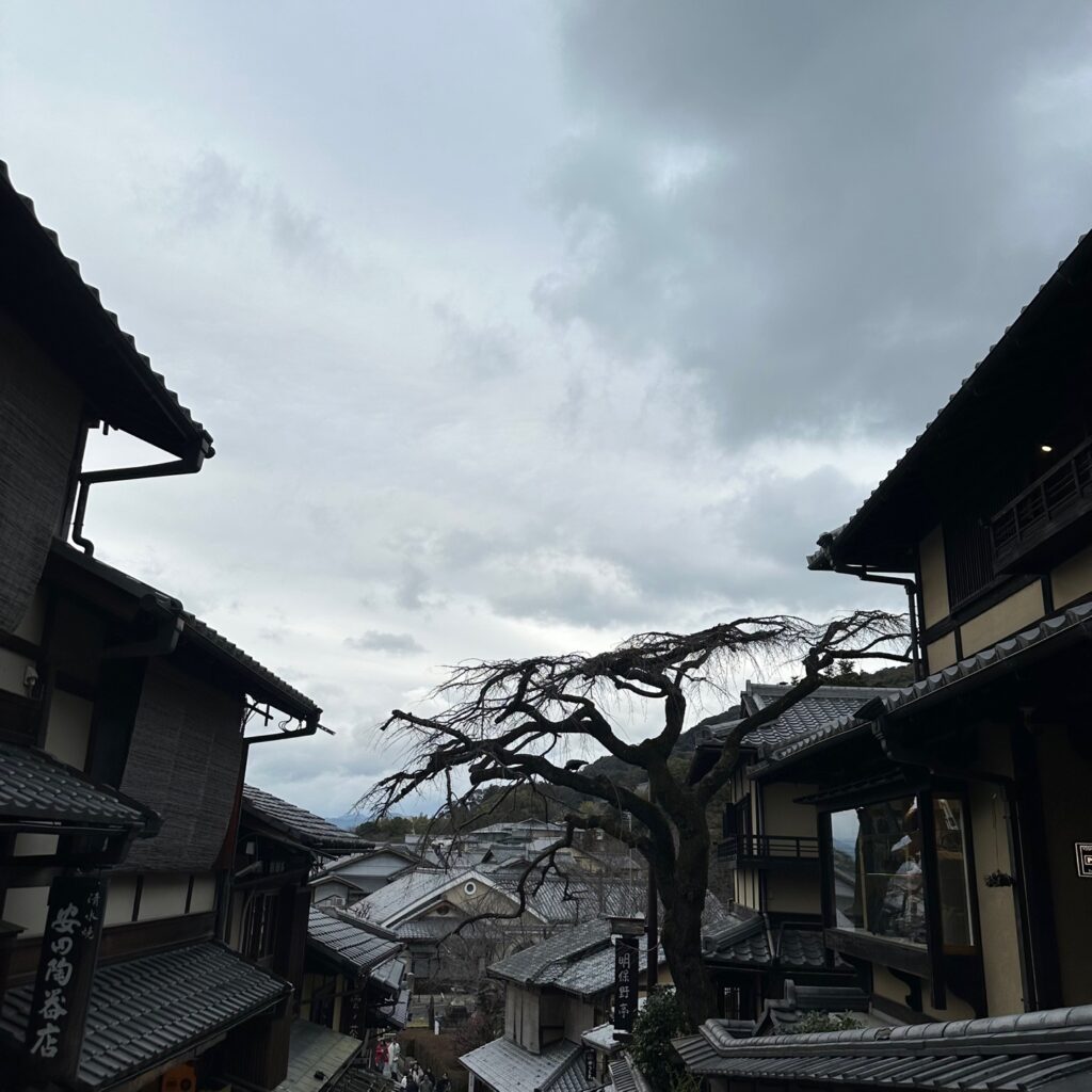 A cloudy sky with a view of traditional Japanese rooftops, providing a serene and calm atmosphere.